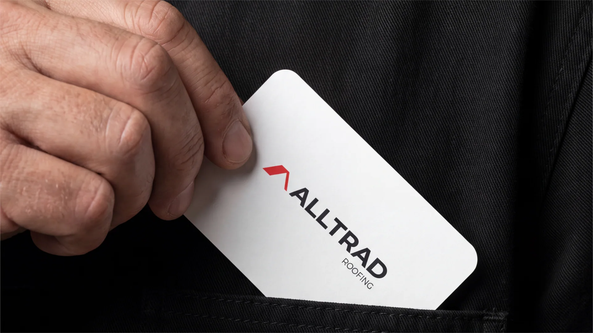 Alltrad Roofing business card held in a hand