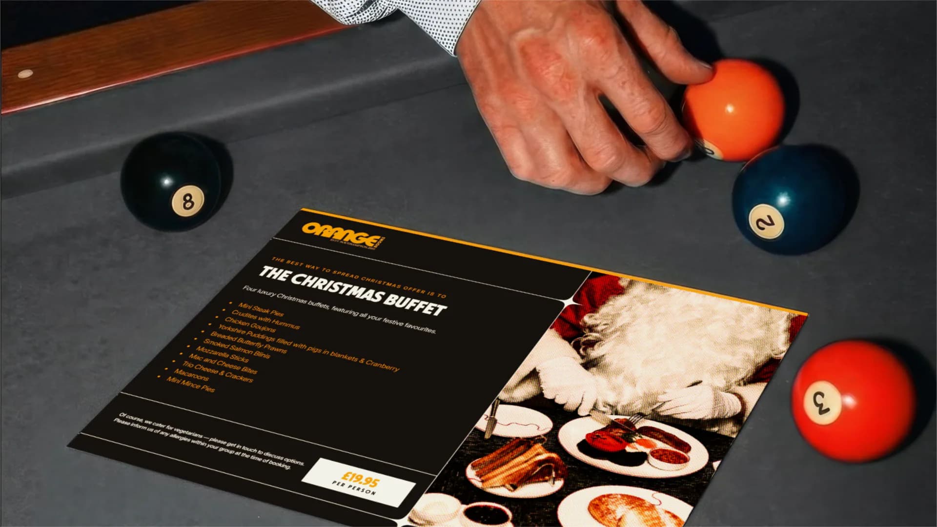 Orange Rooms Christmas buffet menu on a pool table