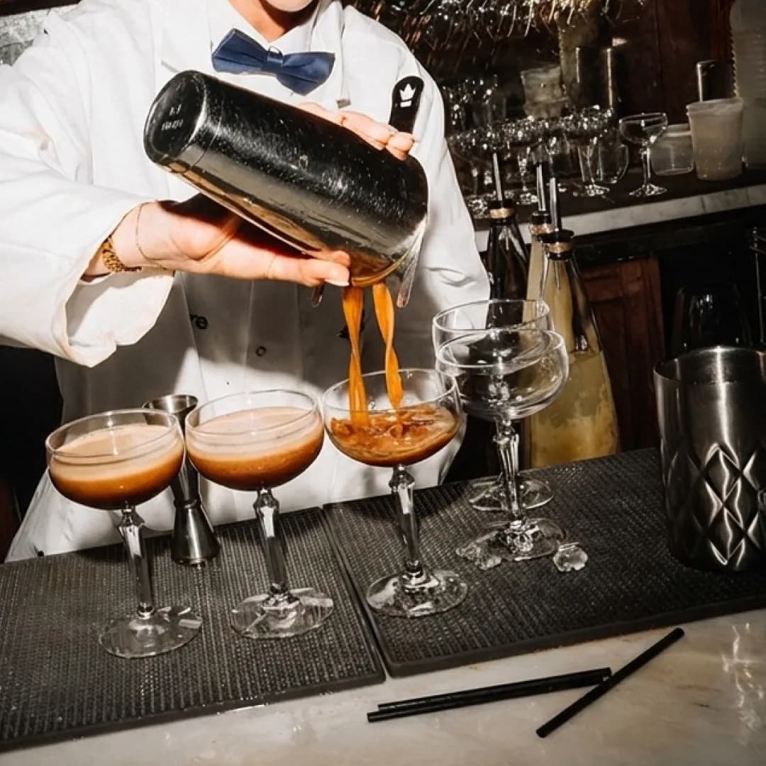 Bartender pouring cocktails at Orange Rooms