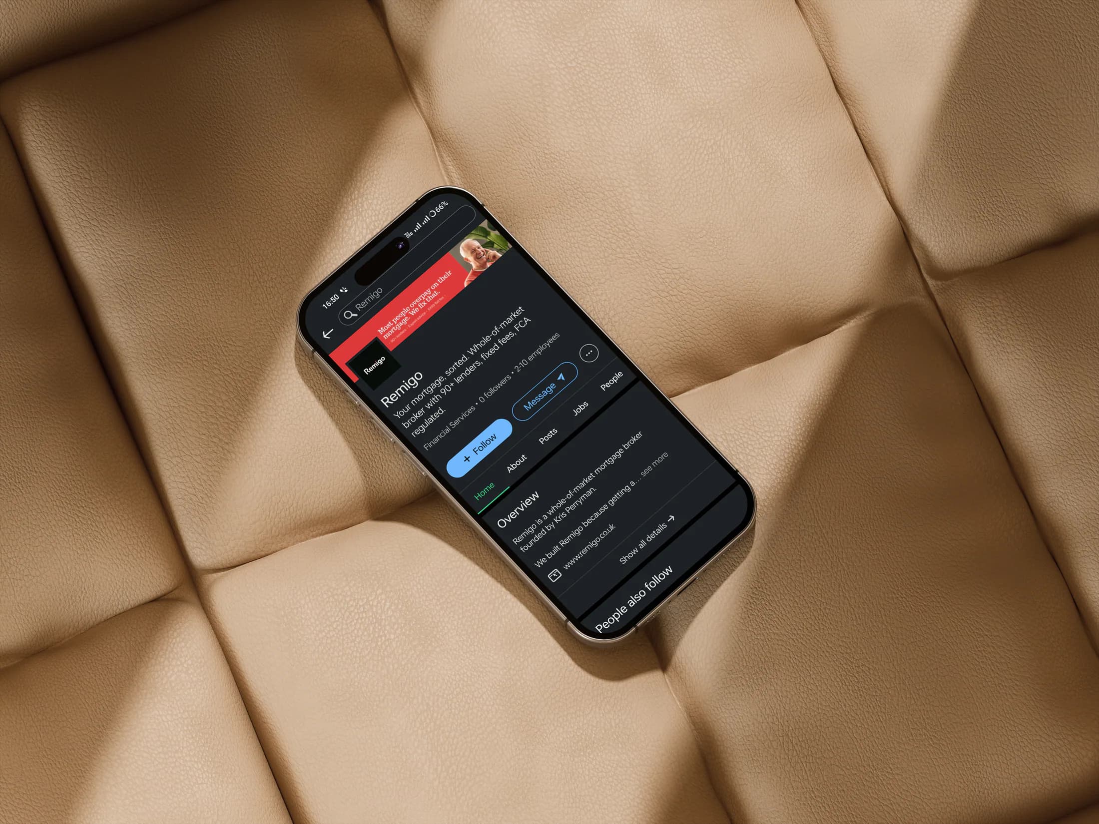 Remigo mobile app on a phone against tan leather