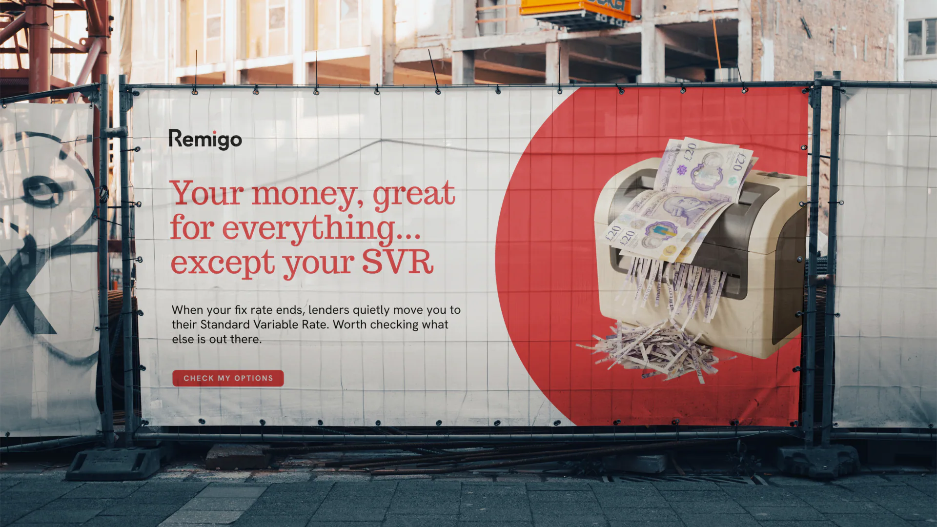 Remigo campaign creative across a large construction fence banner