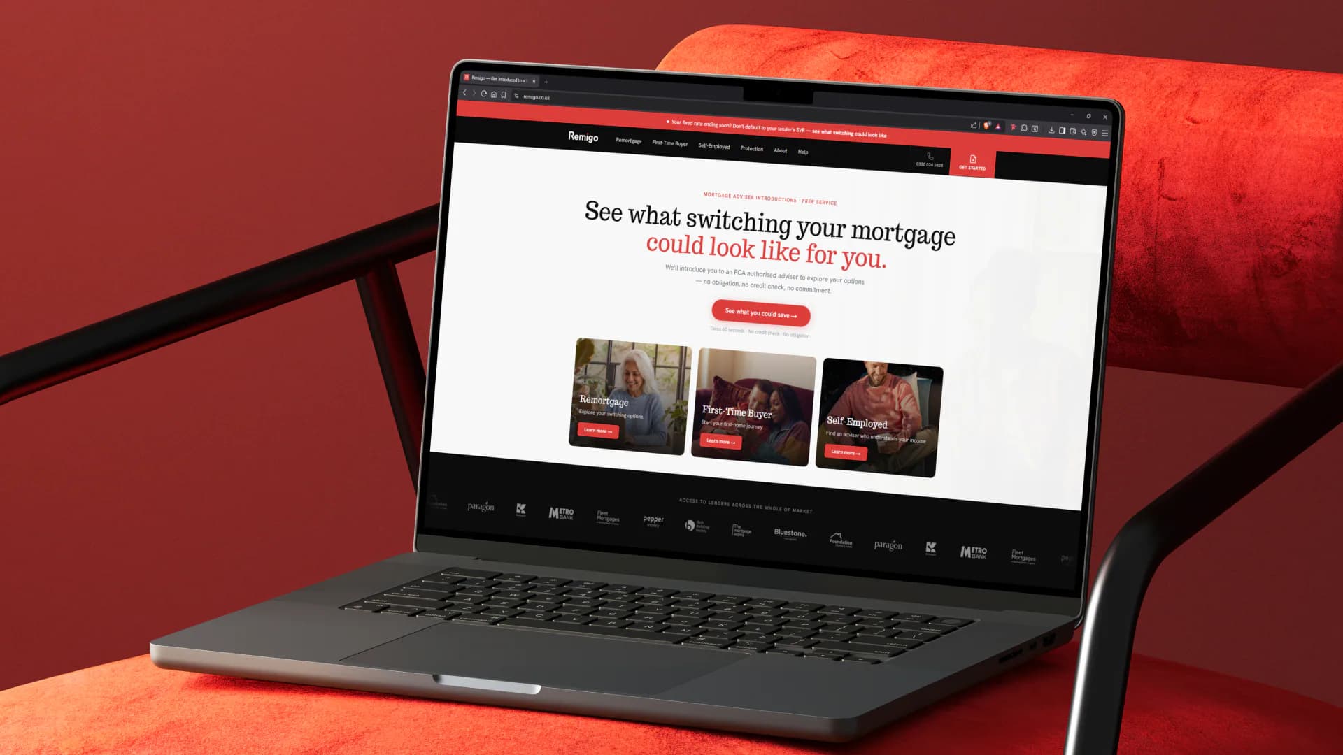 Remigo website on a laptop resting on a red velvet chair
