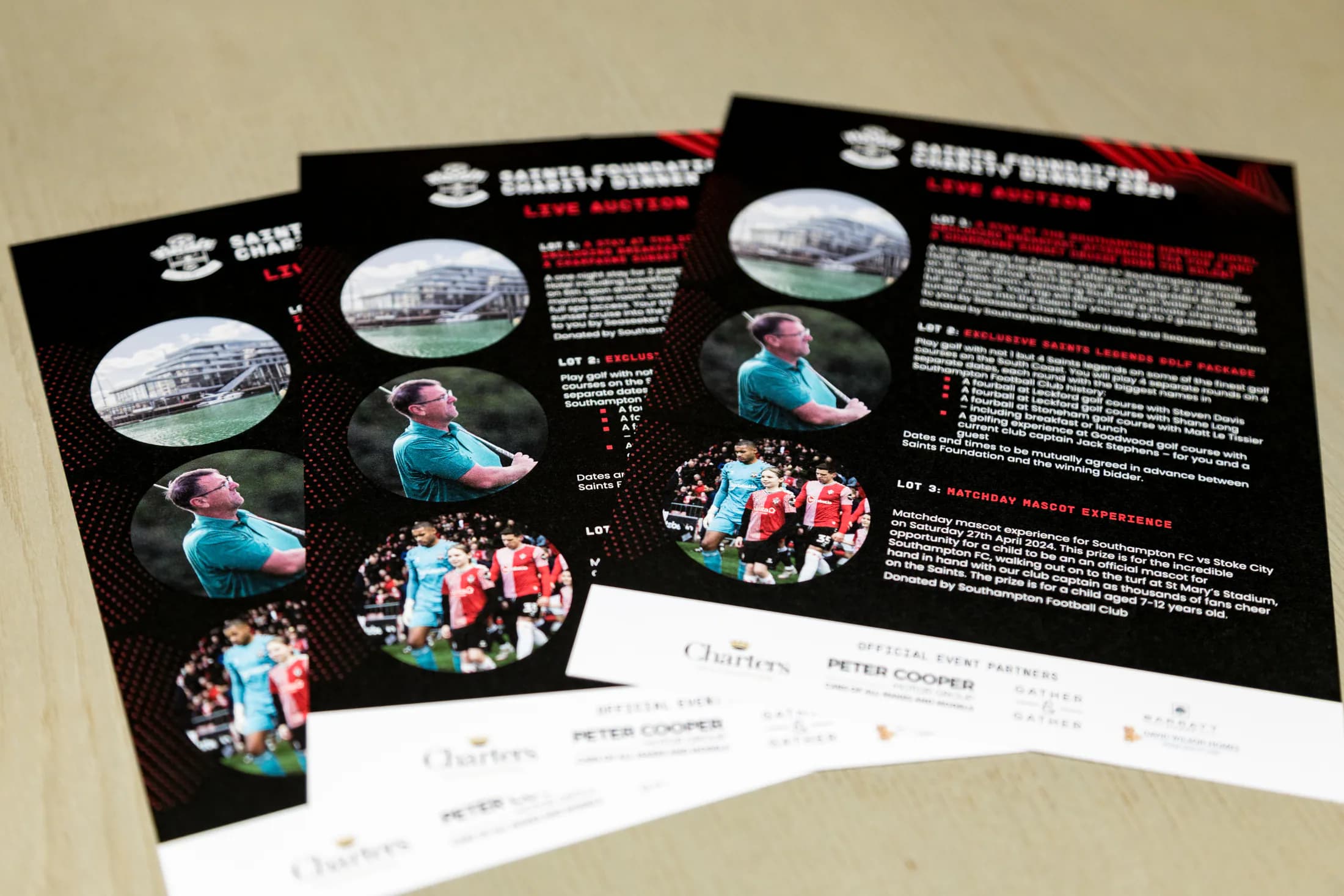 Saints Foundation live auction flyers listing prize lots for the charity dinner