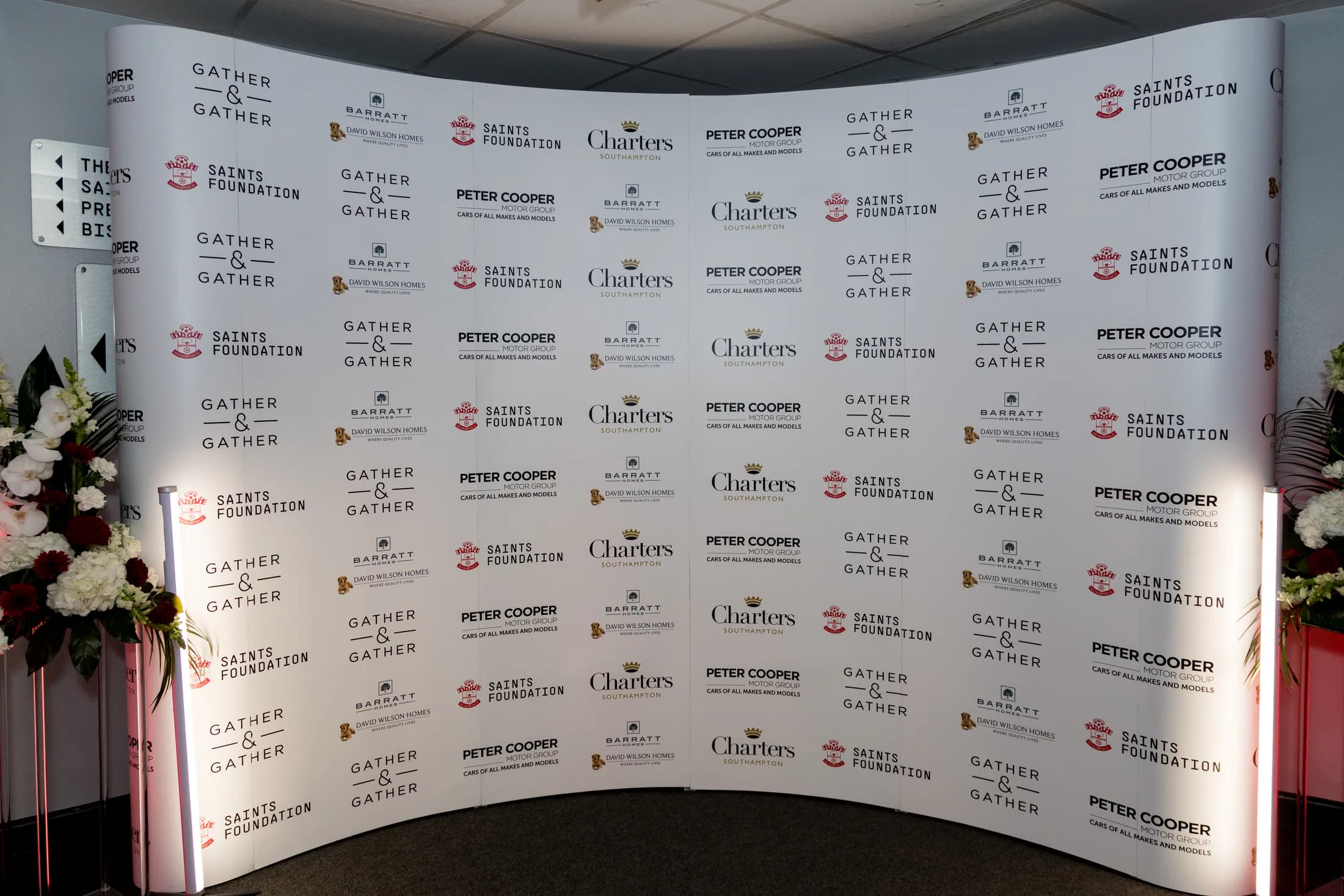 Saints Foundation Charity Dinner media wall with repeating partner logos