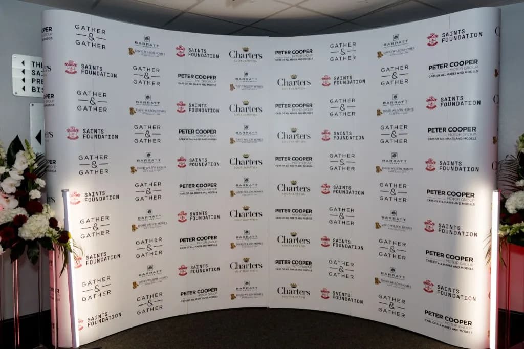 Saints Foundation Charity Dinner media wall with repeating partner logos
