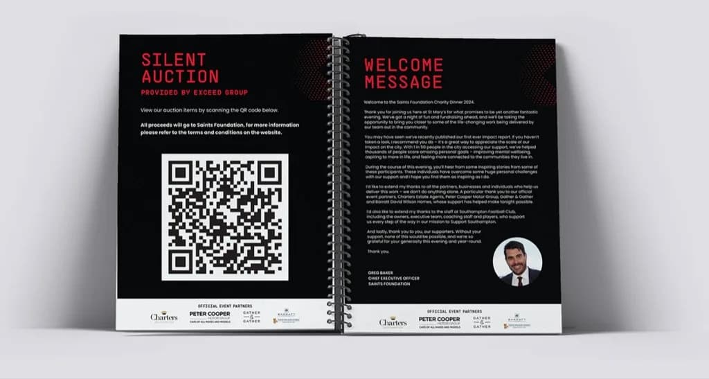 Saints Foundation spiral-bound programme spread with silent auction QR code and welcome message