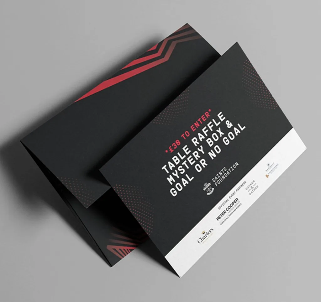 Saints Foundation table raffle and mystery box entry card in the event identity