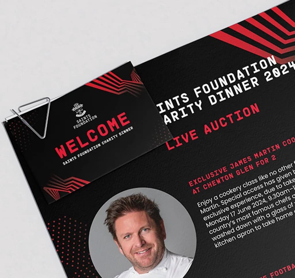 Saints Foundation welcome card clipped to the charity dinner live auction programme