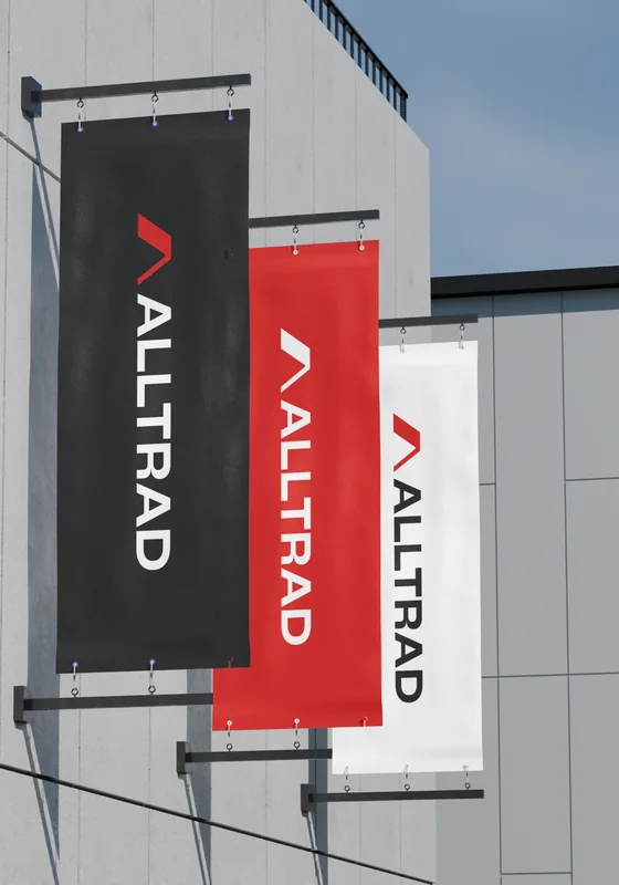 Alltrad Roofing branded site flags flying on location
